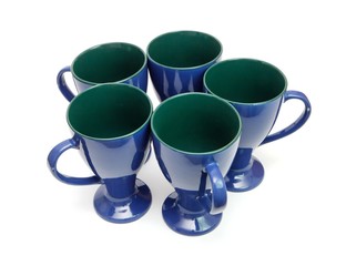 Circle of five blue long-stemmed coffee cups isolated