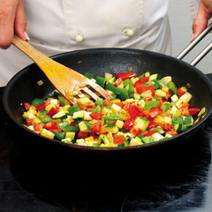 Chef frying peppers