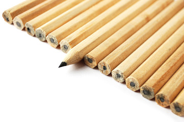 A row of graphite pencils with one in different position