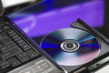 Laptop with a disk dvd. Close up.