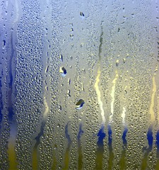 Colorful waterdrops on a steamy window