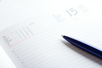 pen on a top of day planner