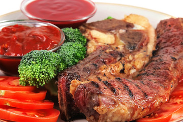 served beef steak and hot chili sauces
