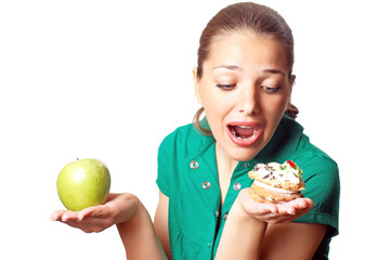 Young pretty woman. Dilema. Apple or cake. Health or tasty.