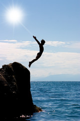 boy jumping to the sea