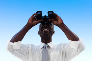 Businessman looking through binoculars