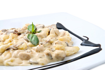 meat under white sauce on the plate