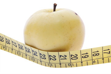 yellow apple and measuring tape