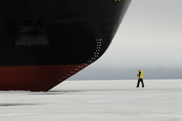 Person at bow of icebreaker, Franz Josef Land, Russia