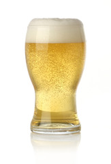 Glass of cold and fresh golden beer, over white background