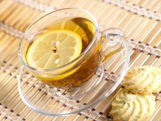 Tea with lemon fruit on bamboo background