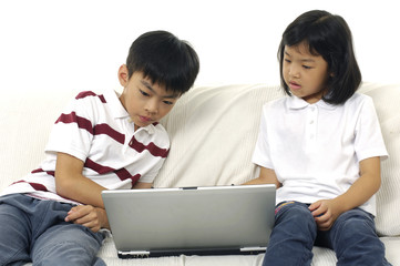 Little boy and girl portrait sitting at notebook