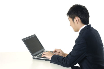 Fototapeta na wymiar businessman working with his laptop at his desk