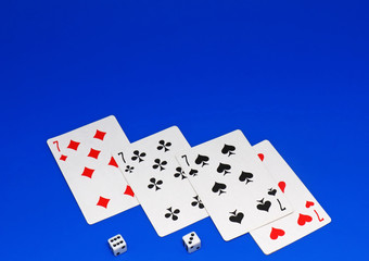 The dice and playing cards on blue   background