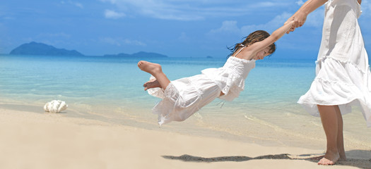 woman and girl on the beach