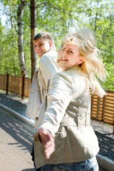 Young couple escaping and smiling
