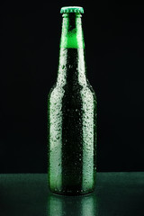 Close up shot of Beer bottle on a black background