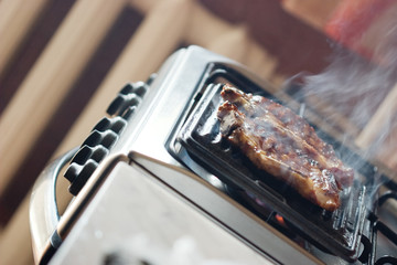 Close-up of cooking steak in the kitchen