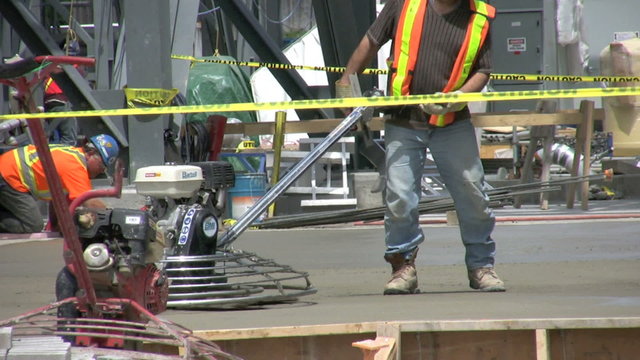 Footage of workers buffing (finishing) concrete