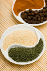 many different spices in plates