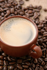 cup of espresso on coffee ben with burlap background