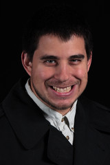 sinister smile of male portrait isolated on black background