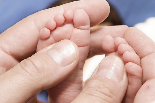 Adult´s hand and baby´s foot
