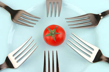 forks and tomato on dish