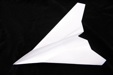 Paper plane on black background