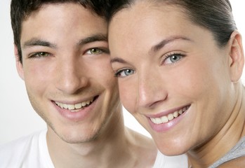 Beautiful young couple closeup portrait over white
