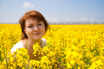 Fototapeta premium beautiful woman on the rape field