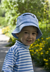 Half-length portrait of a smiling little boy on a background of