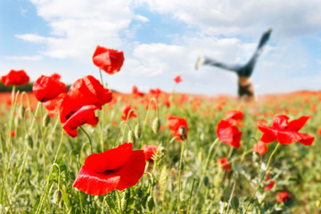 jumping girl in poppy field