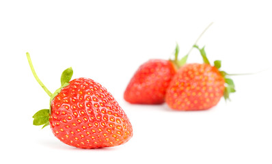 three strawberries on white