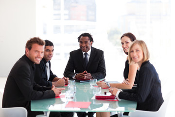 Business people looking at the camera in a meeting