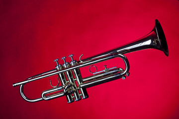 Obraz na płótnie Canvas Gold Trumpet Isolated On Red