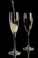 Sparkling wine poured into champagne flutes