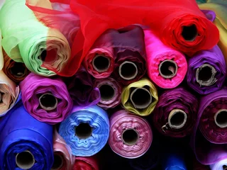 Abwaschbare Fototapete Staub Rolls of multi-coloured fabric
