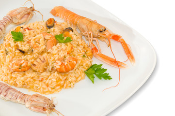 Risotto with cherry tomatoes and seafood. Italian food.