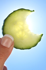 Fingers holding cucumber