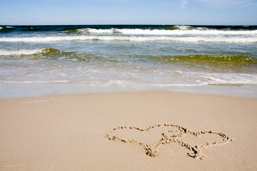Two hearts drawn on beach