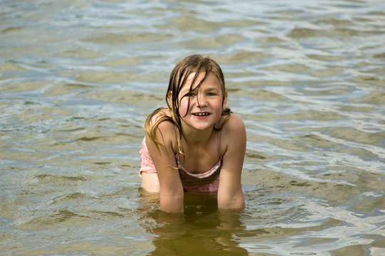 little girl is playing in the water