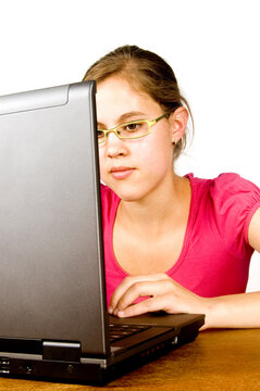 actractive young female is studying behind a laptop