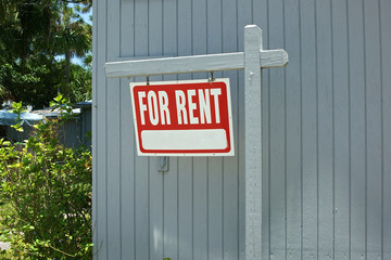 for rent sign hanging from post
