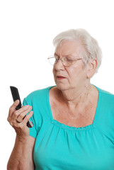 Senior woman trying to use a cell phone