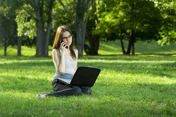 student with laptop outdoors