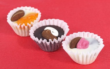 Chocolate candies on red paper napkin