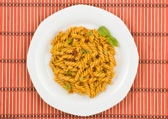 Italian pasta, with tomato sauce and basil.