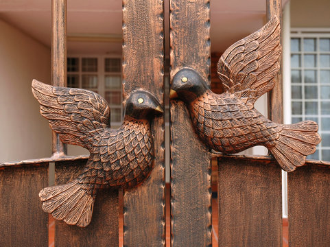 pigeons statue on metal door