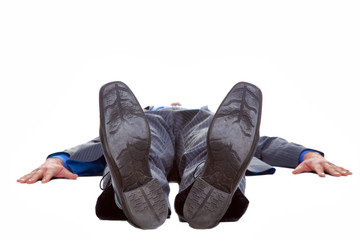 Businessman lying on his back isolated
